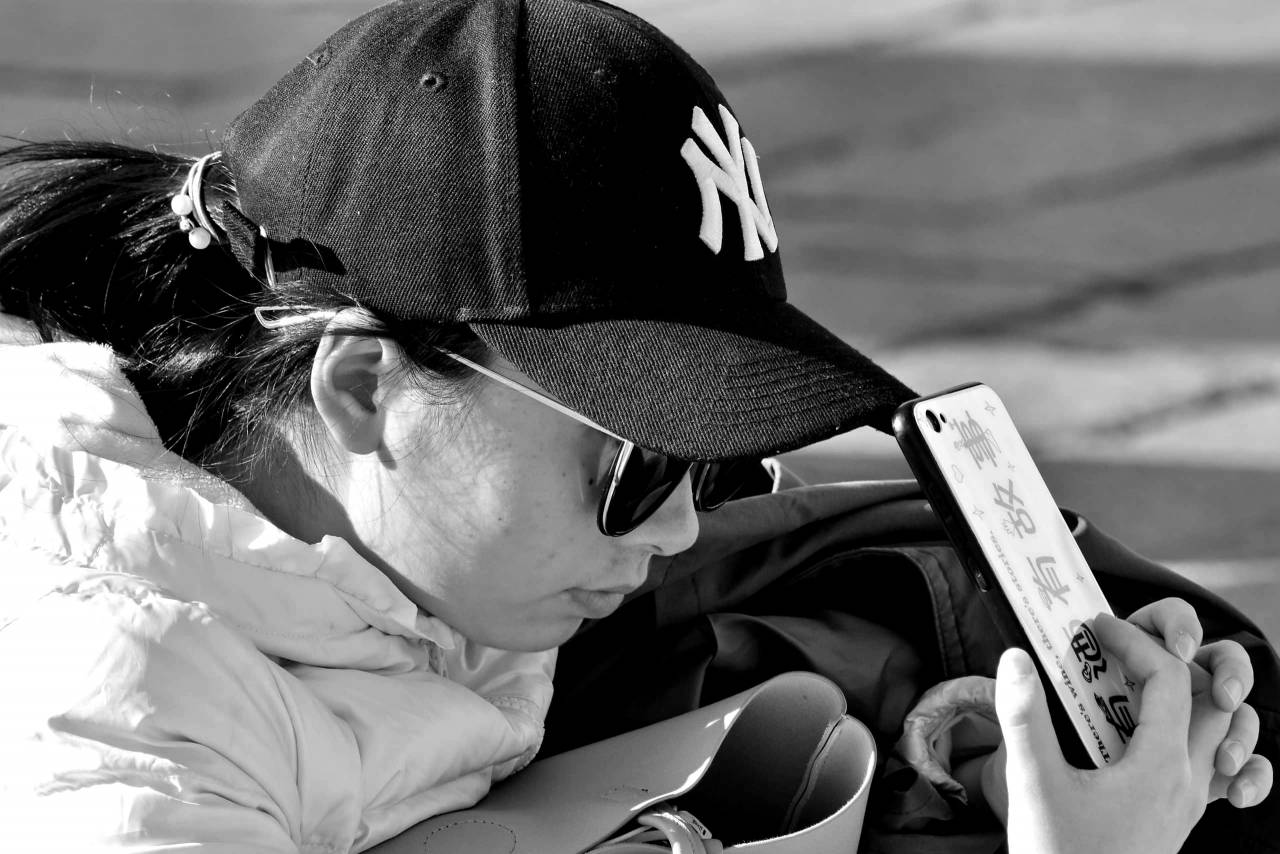 asian cellphone hat side sunglasses outdoors woman  kb — free black and white photo