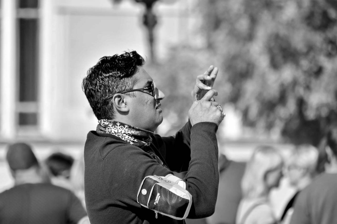 asian handsome eyeglasses side street portrait hands outdoors — free black and white photo