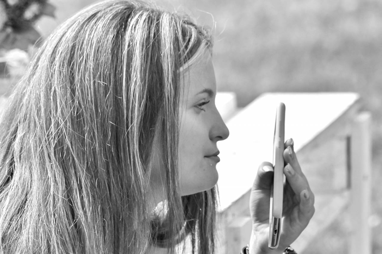 phone pretty mobile hand woman relaxing hairstyle casual sunshine person summer  — free black and white photo