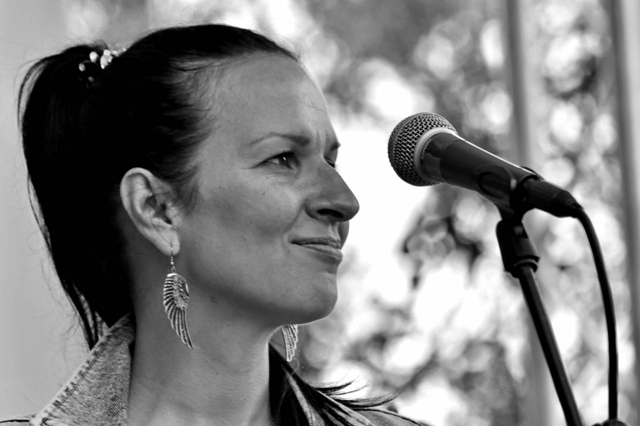 singing smiling pretty woman enjoying microphone portrait music lifestyle — free black and white photo