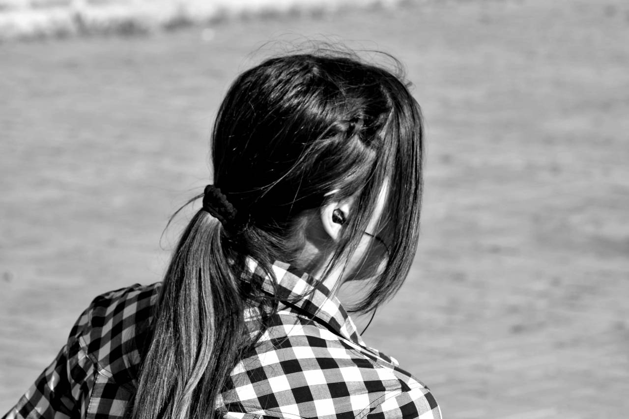 adolescence brunette portrait park earphones relaxation outdoors nature — free black and white photo
