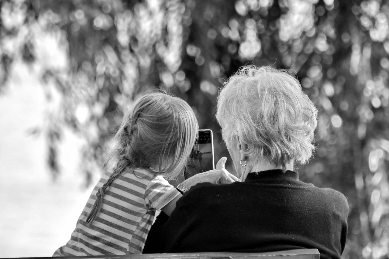 grandmother granddaughter happy phone outdoors entertainment mobile summer season enjoyment kb — free black and white photo