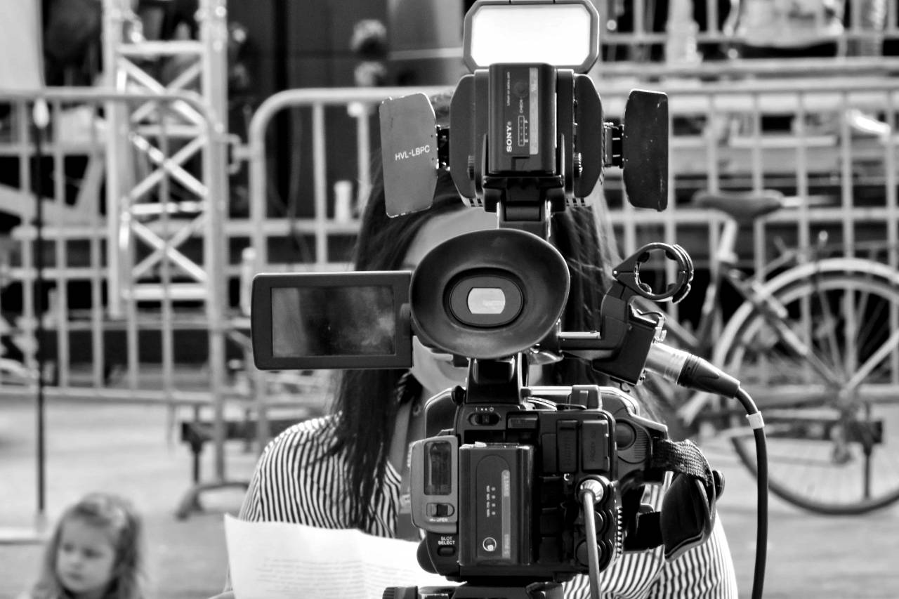 journalist recording equipment tripod camera lens television machinery industry technology — free black and white photo