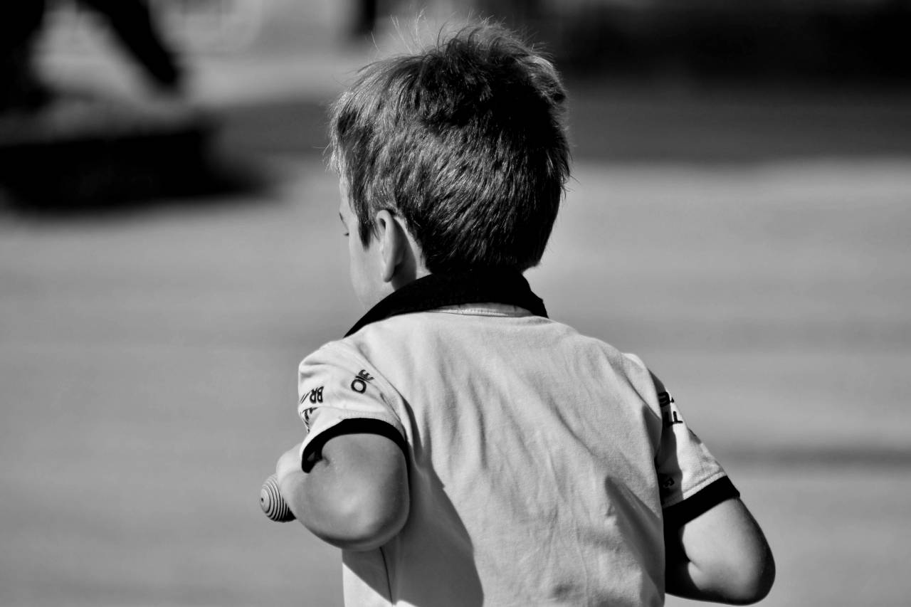 playful blur outdoors boy child portrait nature street — free black and white photo
