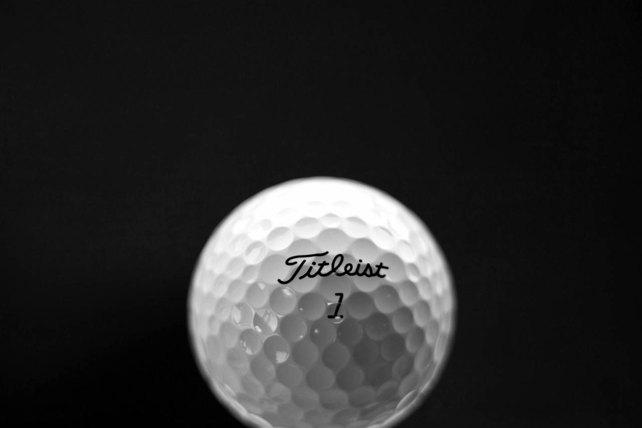  golf ball  golf equipment  sports equipment  — free black and white photo