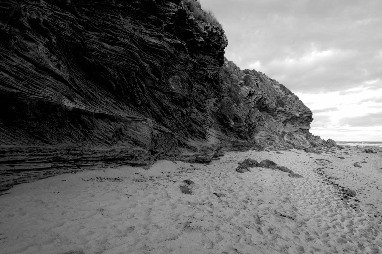   beach  sea  coast  nature  sand  rock  ocean  — free black and white photo