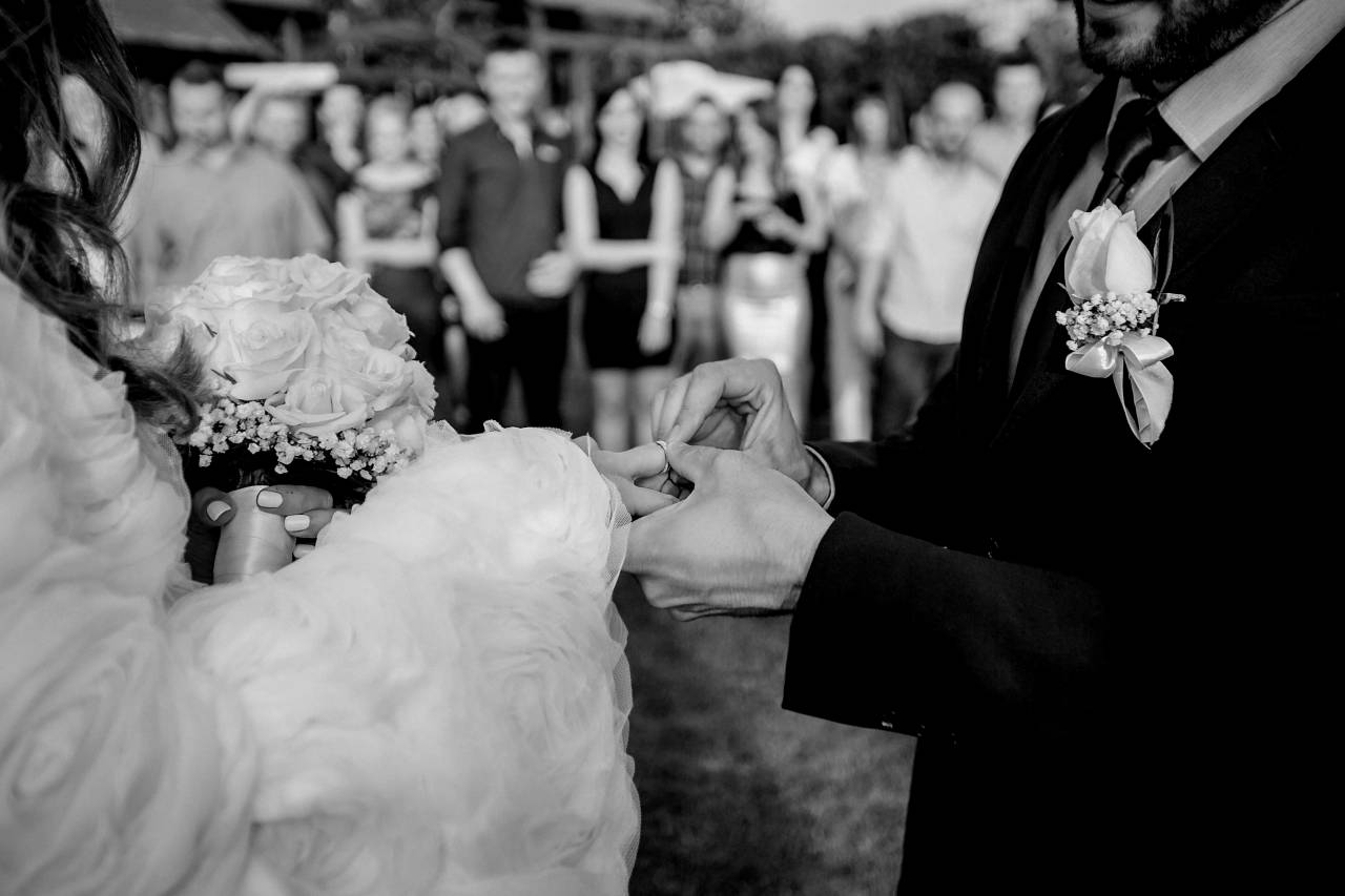 ceremony ring groom bouquet bride crowd married couple  — free black and white photo