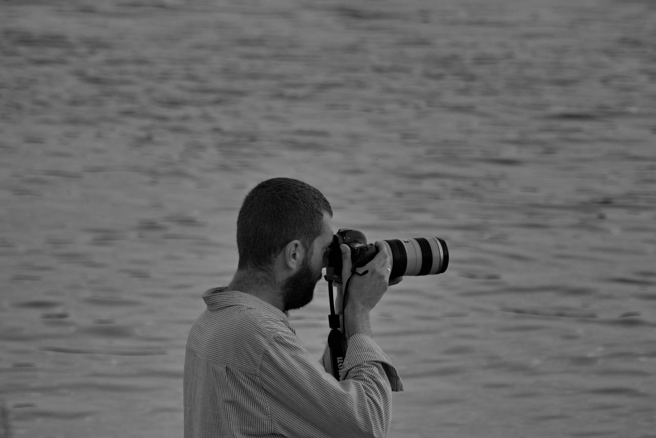 horizon lens photographer camera water leisure device outdoors nature — free black and white photo