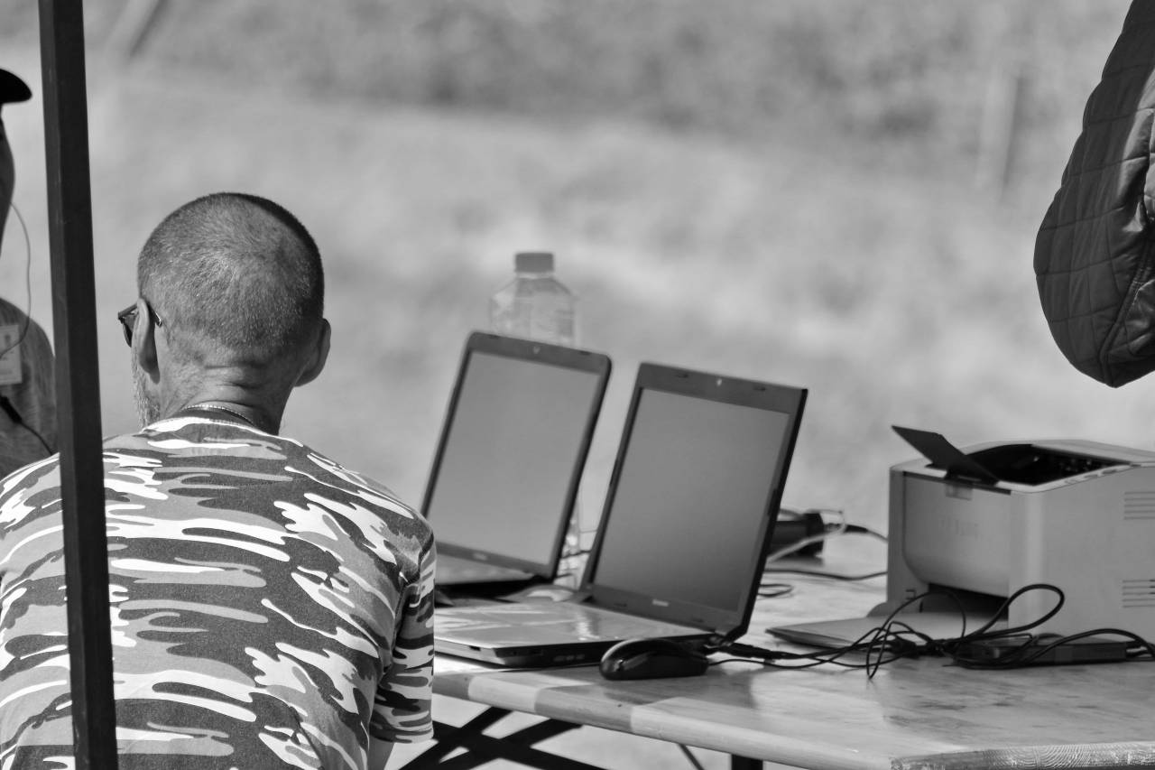 laptop working programmer engineer field computer desk notebook — free black and white photo
