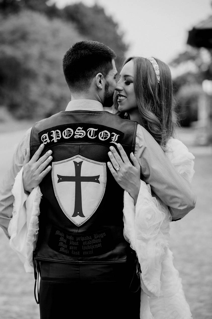 motorcyclist hugging groom bride kiss woman wedding man  — free black and white photo