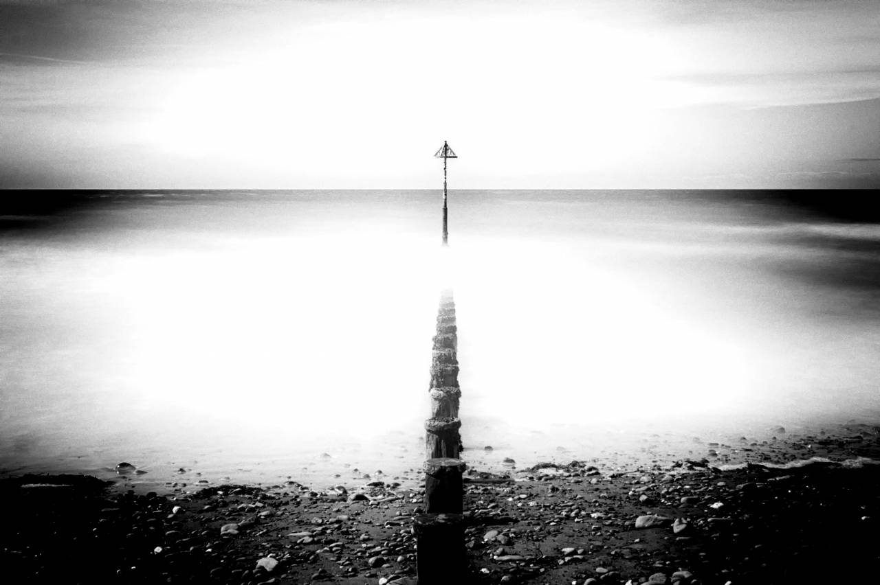   beach  sea  coast  water  sand  rock  — free black and white photo