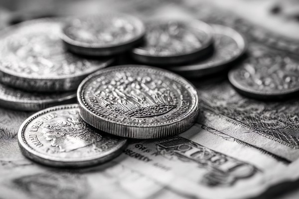 abstract composition of coins and paper money macro detail fo — black and white background photo