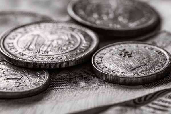 abstract composition of coins and paper money macro detail fo — black and white background photo