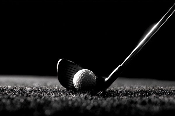 black and white golf picture close up of golfer mid swing mot — black and white photo