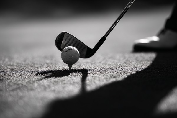 black and white golf picture close up of golfer mid swing mot — black and white photo