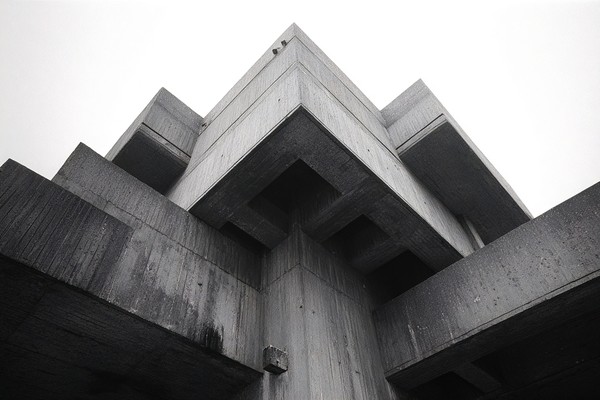 brutalist concrete architecture strong geometric shapes and h — black and white city photo