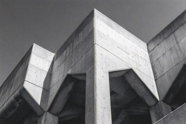 brutalist concrete architecture strong geometric shapes and h — black and white city photo