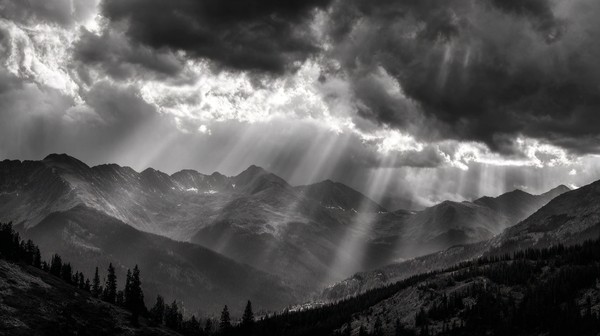 dramatic mountain range landscape storm clouds gathering rays — black and white landscape photo