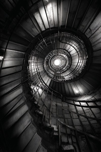 fine art photograph of a spiral staircase looking down hypnot — black and white photo