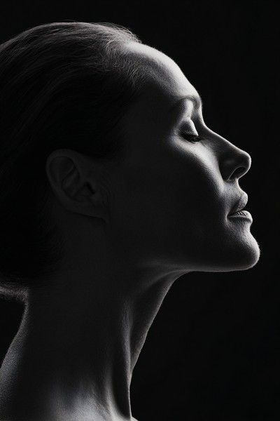 minimalist profile portrait of a woman strong jawline hair pu — black and white photo