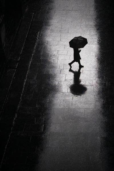 silhouettes mysterious silhouette of a person with an umbrell — black and white photo