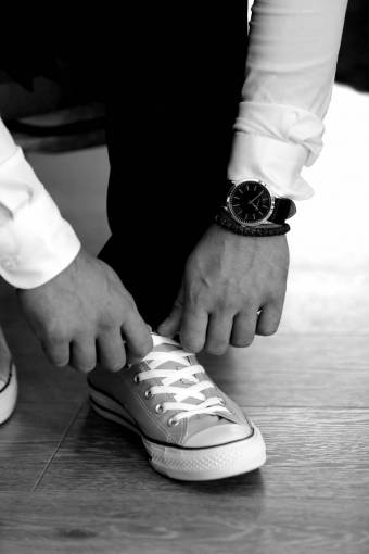 businessman wristwatch sneakers casual pants footwear covering foot  — black and white photo