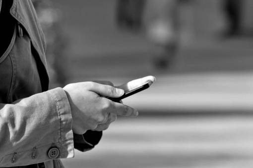 mobile phone communication telecommunication device outdoors street blur hand