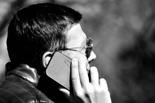 phone ear hand mobile profile side telephone telecommunication businessman businessperson  — black and white photo