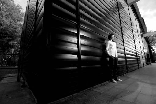 gentleman posing wait corner standing door street — black and white photo