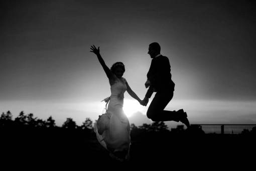 happiness sunset jump jumping silhouette cheerful groom bride sun kb — black and white photo