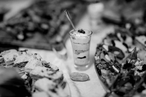 buffet salad appetizer pudding cream glass banquet dinner restaurant  — black and white photo