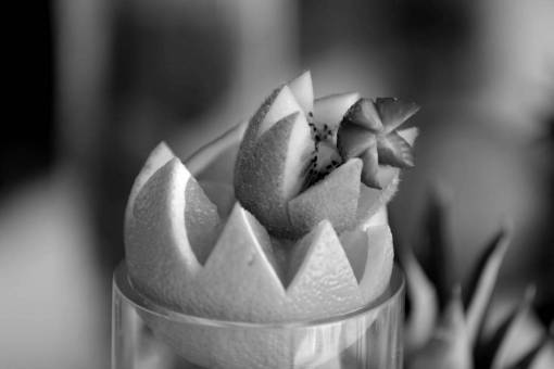 fruit cocktail kiwi oranges appetizer strawberries carvings mandarin citrus tasty  — black and white photo